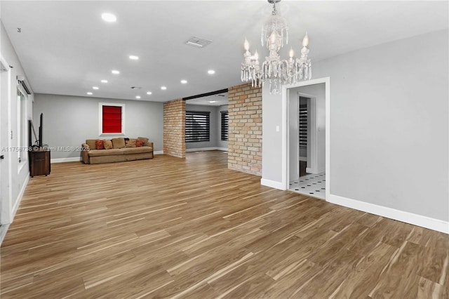 unfurnished living room featuring recessed lighting, light wood-type flooring, baseboards, and visible vents