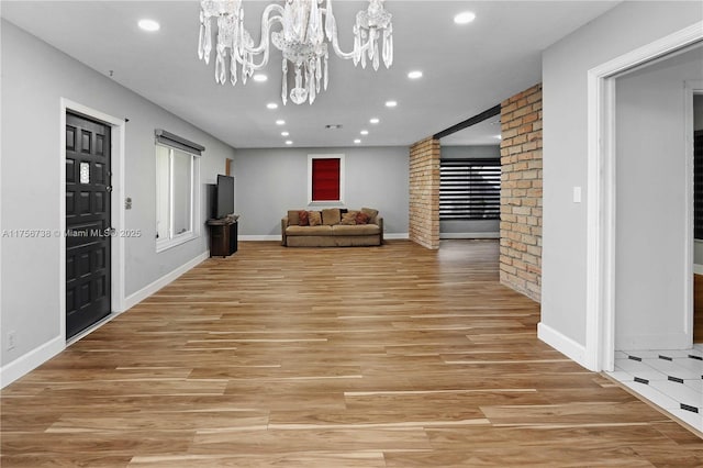 interior space with recessed lighting, light wood-type flooring, and an inviting chandelier