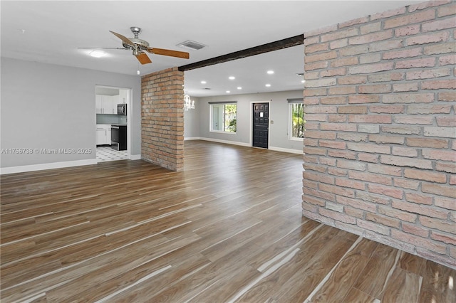 unfurnished living room featuring wood finished floors, visible vents, baseboards, recessed lighting, and ceiling fan