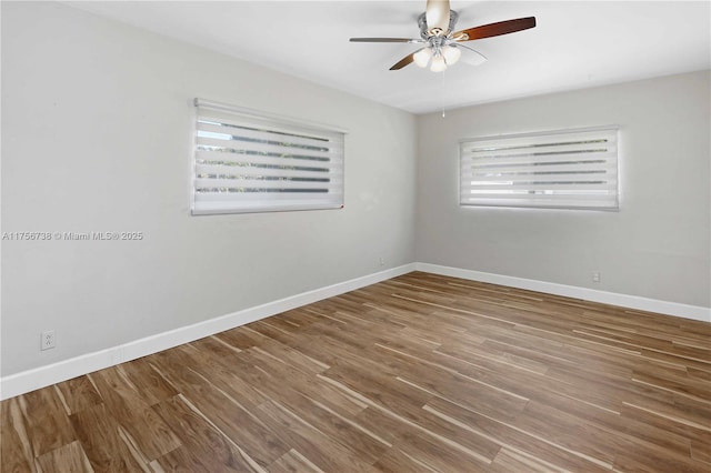 spare room with a ceiling fan, baseboards, and wood finished floors