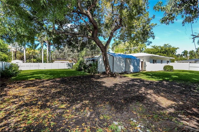 view of yard featuring an outdoor structure and fence