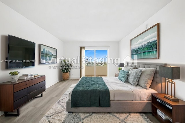 bedroom with wood finished floors and baseboards