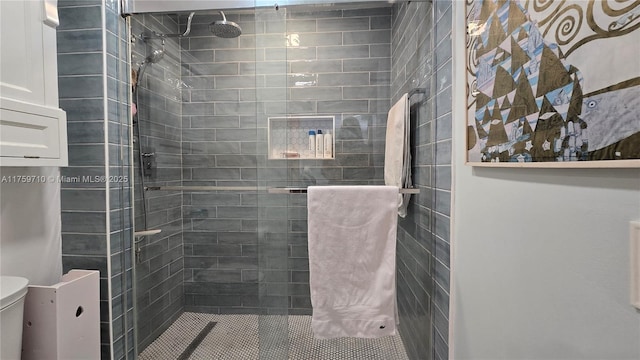 full bathroom with tiled shower and toilet