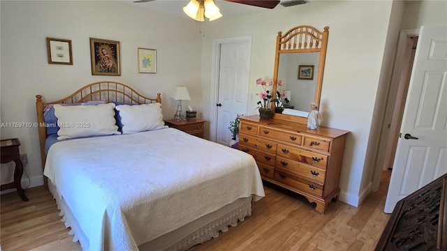 bedroom featuring baseboards, ceiling fan, and light wood finished floors