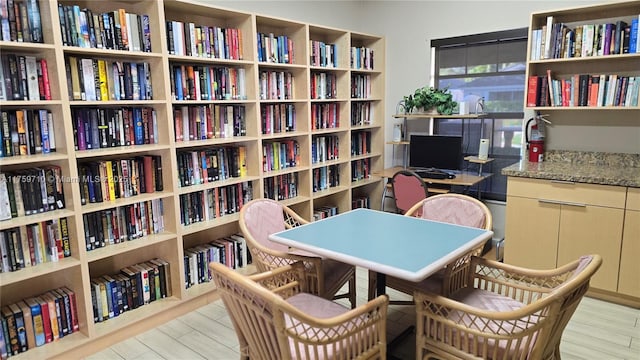 office with bookshelves and wood finished floors