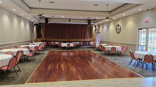 playroom with visible vents, a raised ceiling, and wood finished floors