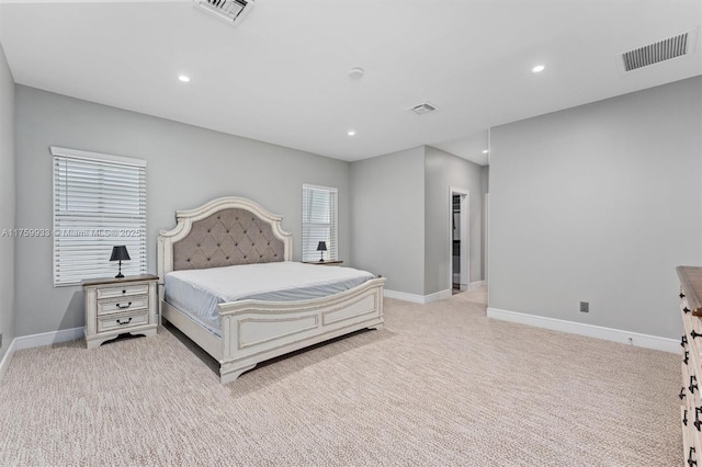 carpeted bedroom featuring recessed lighting, visible vents, and baseboards