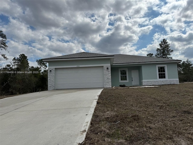 ranch-style home featuring stone siding, stucco siding, concrete driveway, and a garage