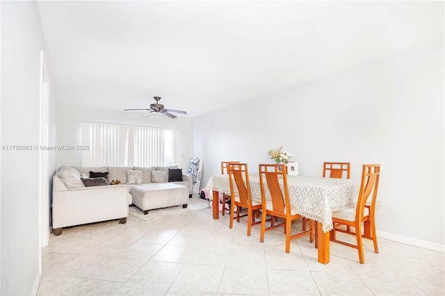 dining space with light tile patterned flooring, baseboards, and a ceiling fan