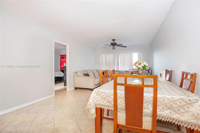 dining area featuring light tile patterned floors, baseboards, and a ceiling fan