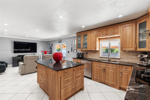 kitchen featuring a sink, open floor plan, a center island, light tile patterned flooring, and dishwasher