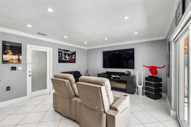 home theater with visible vents, light tile patterned flooring, and ornamental molding