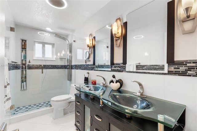 bathroom featuring a shower stall, toilet, tile walls, and a sink