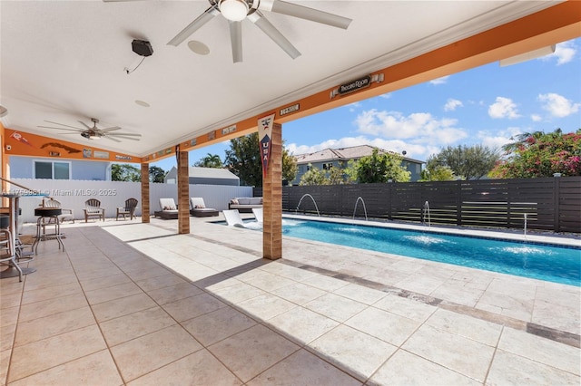 view of swimming pool with a ceiling fan, a patio area, a fenced backyard, and a fenced in pool