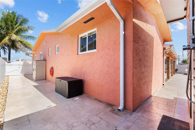 view of home's exterior featuring a patio, fence, and stucco siding