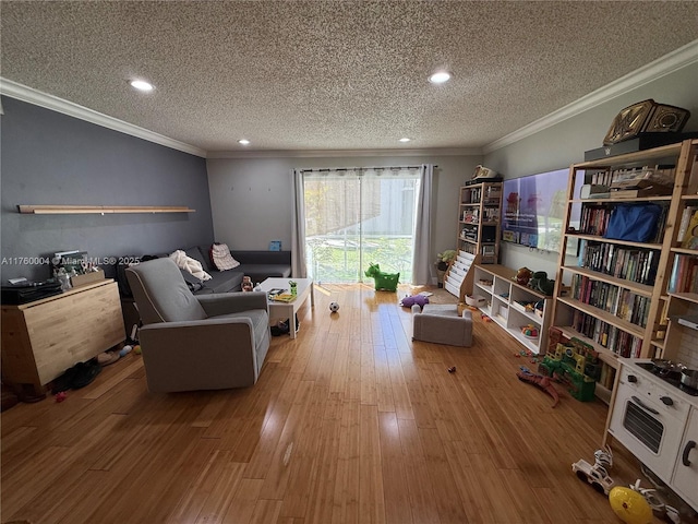 living area featuring a textured ceiling, wood finished floors, and crown molding