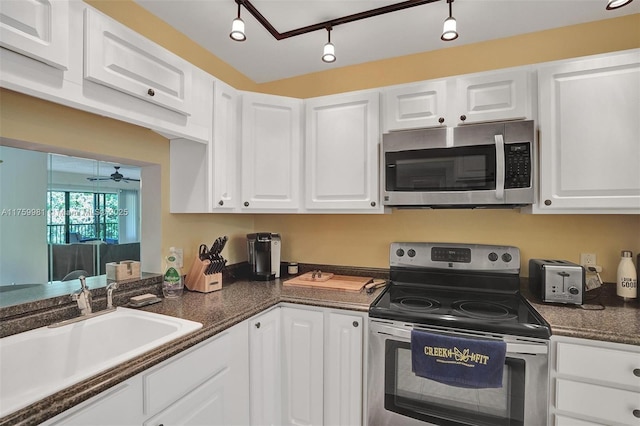 kitchen featuring white cabinets, appliances with stainless steel finishes, ceiling fan, and a sink