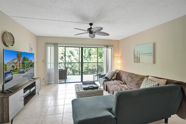 living area with a textured ceiling, light tile patterned flooring, and a ceiling fan