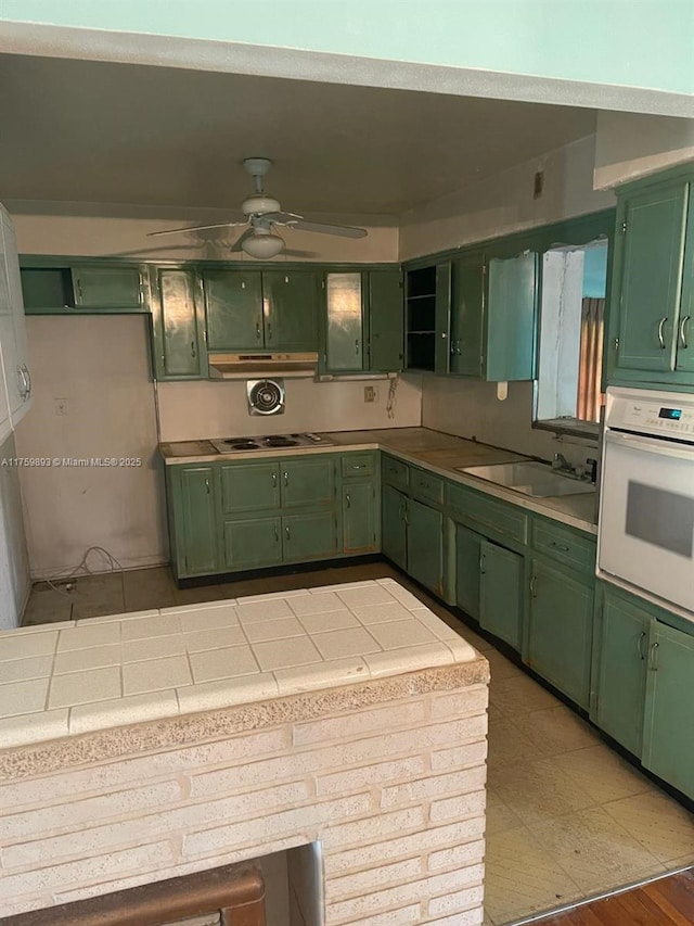 kitchen featuring green cabinets and white oven