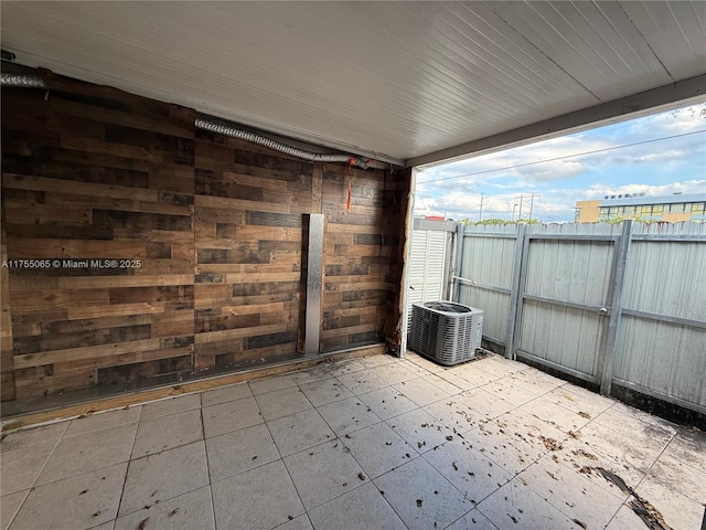 view of patio / terrace featuring cooling unit and fence