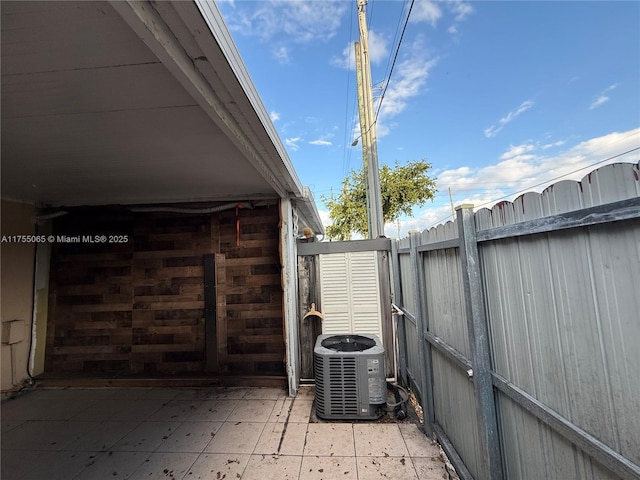 view of patio featuring central AC and fence