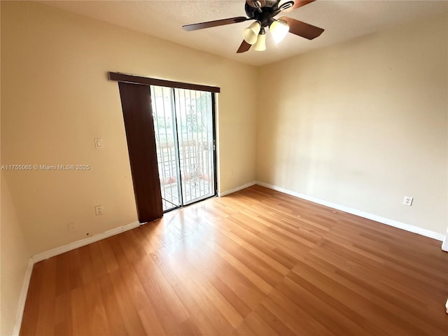 empty room with baseboards, light wood-style floors, and a ceiling fan