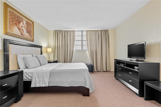 bedroom featuring light colored carpet