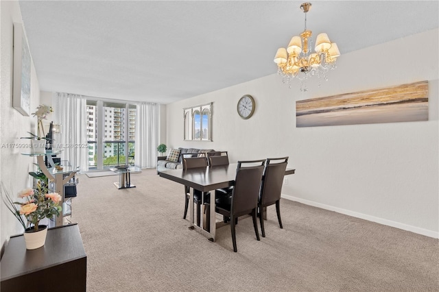 dining space with an inviting chandelier, baseboards, and carpet floors