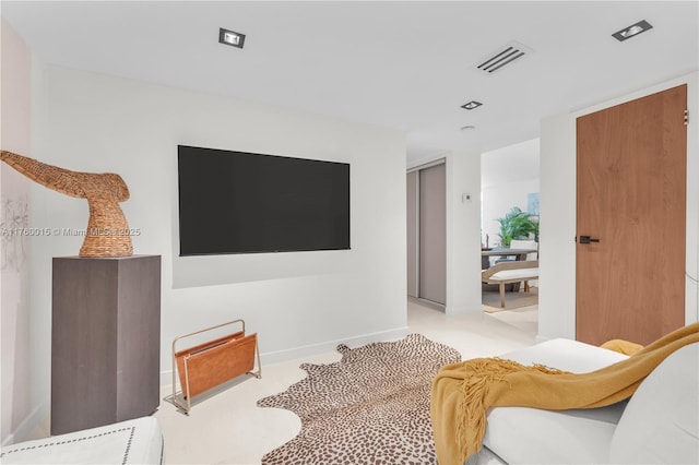 living room with baseboards and visible vents