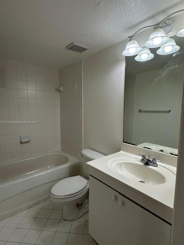 full bathroom with visible vents, toilet, vanity, tile patterned floors, and a textured ceiling