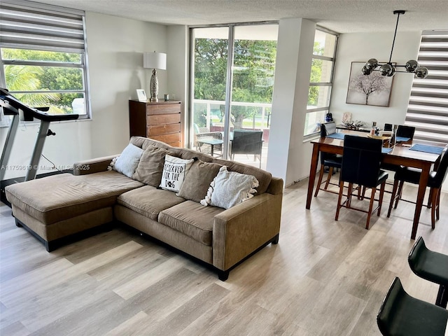 1351 NE Miami Gardens Dr Unit 325E, Miami, FL 33179 - living area featuring a healthy amount of sunlight, a textured ceiling, and light wood-style floors