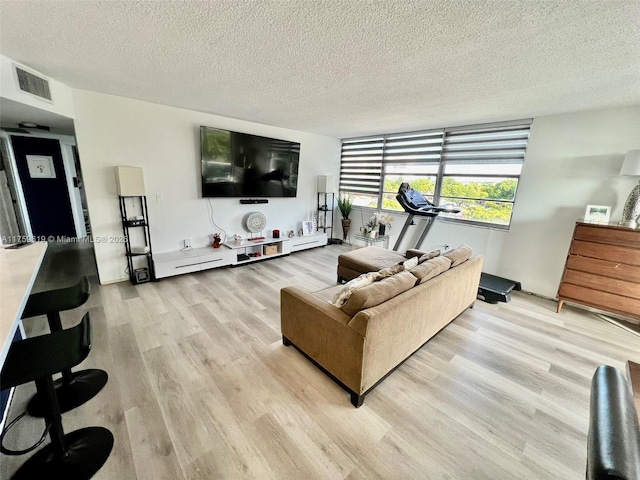 1351 NE Miami Gardens Dr Unit 325E, Miami, FL 33179 - living area featuring visible vents, a textured ceiling, and light wood-style flooring