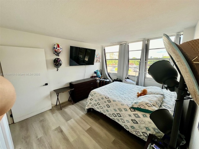 1351 NE Miami Gardens Dr Unit 325E, Miami, FL 33179 - bedroom featuring light wood-style flooring and a textured ceiling