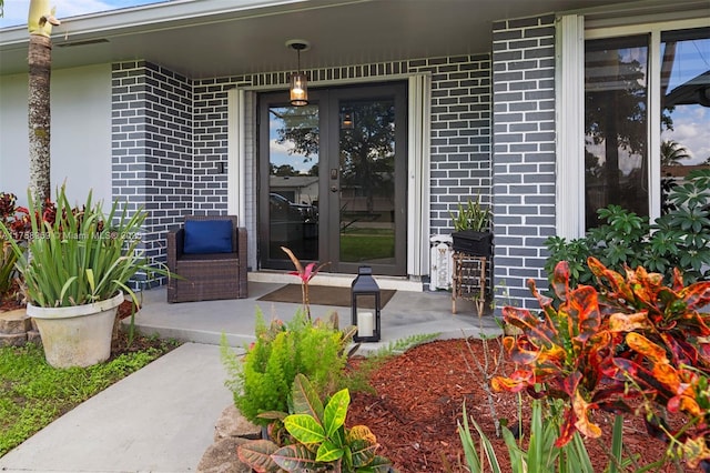 doorway to property with brick siding