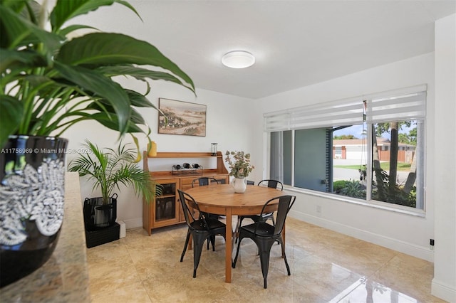 dining space featuring baseboards