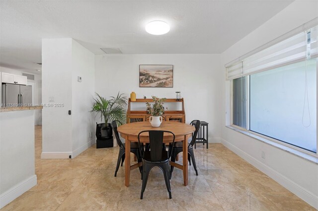dining area featuring baseboards
