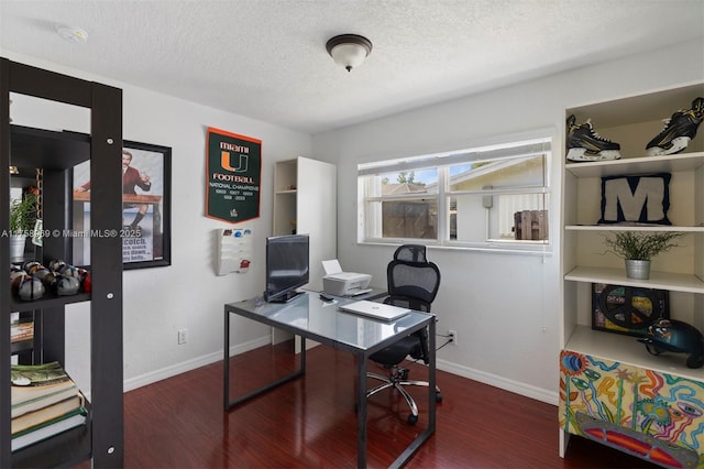 office space featuring a textured ceiling, baseboards, and wood finished floors