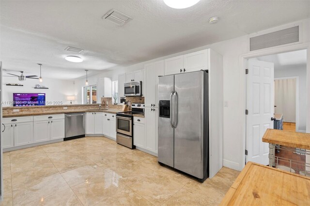 kitchen featuring white cabinetry, visible vents, and appliances with stainless steel finishes