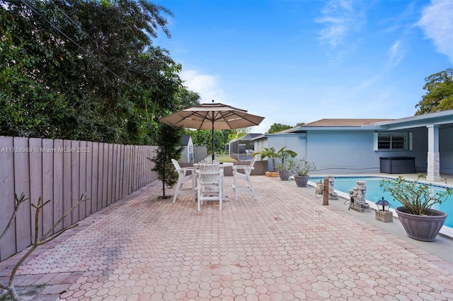 view of patio featuring a fenced in pool, outdoor dining area, and a fenced backyard