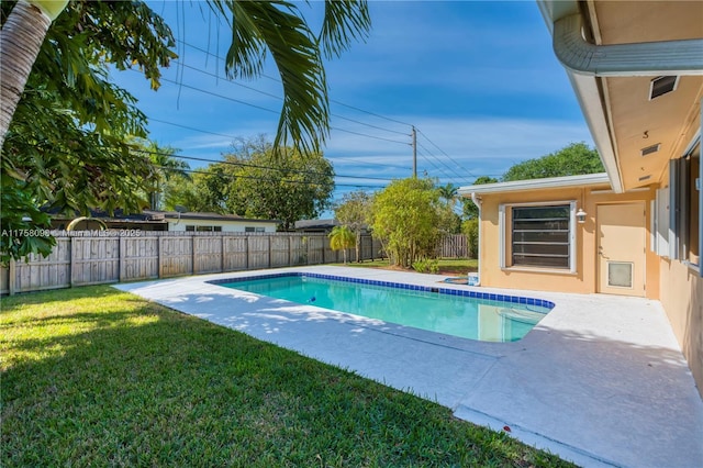 view of pool featuring a patio area, a lawn, a fenced backyard, and a fenced in pool