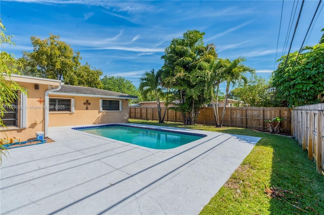 view of pool with a patio, a yard, a fenced backyard, and a fenced in pool