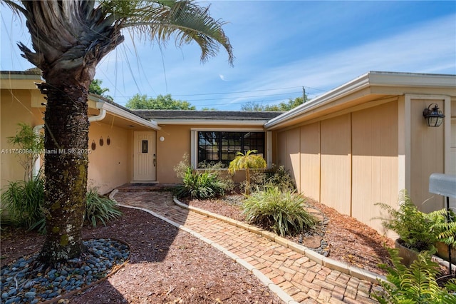 doorway to property with stucco siding