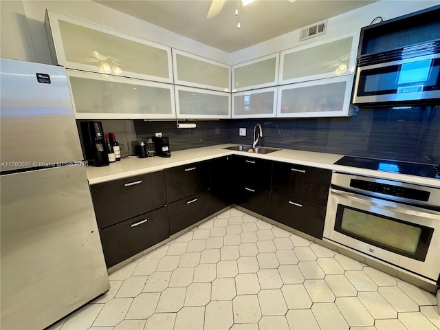3660 NE 166th St Unit 812, North Miami Beach, FL 33160 - kitchen with stainless steel appliances, ceiling fan, backsplash, and light countertops