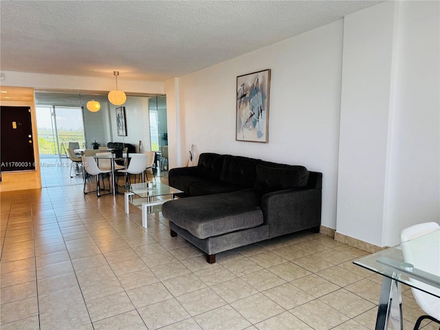 3660 NE 166th St Unit 812, North Miami Beach, FL 33160 - living area with a textured ceiling and light tile patterned floors