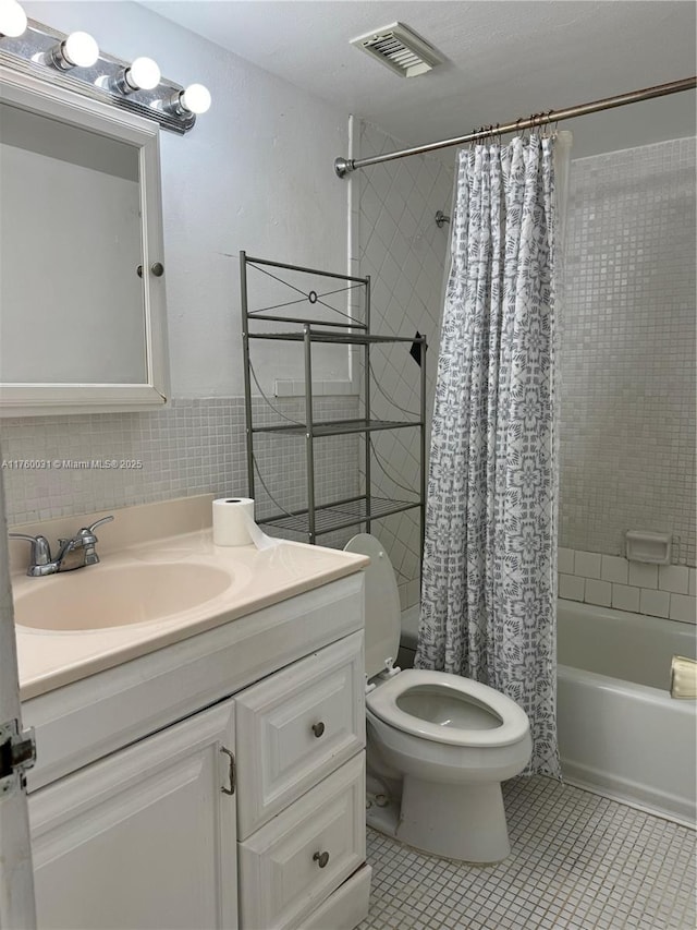 bathroom featuring visible vents, toilet, tile patterned floors, vanity, and shower / bathtub combination with curtain