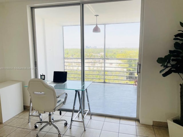 office area with light tile patterned flooring and expansive windows