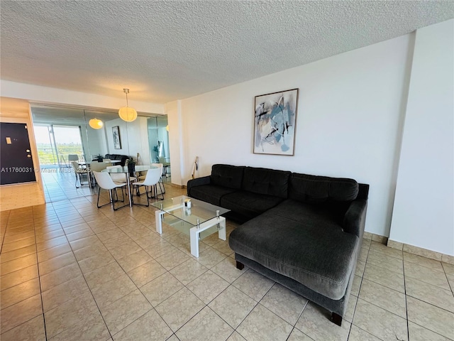3660 NE 166th St Unit 812, North Miami Beach, FL 33160 - living room featuring light tile patterned floors and a textured ceiling