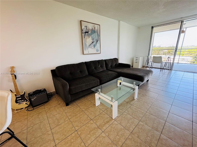 3660 NE 166th St Unit 812, North Miami Beach, FL 33160 - living area featuring light tile patterned flooring, a textured ceiling, and floor to ceiling windows