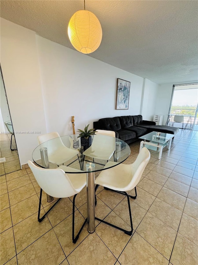 3660 NE 166th St Unit 812, North Miami Beach, FL 33160 - dining area with a textured ceiling and light tile patterned floors