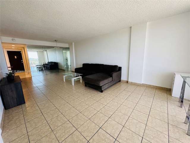 living room with light tile patterned floors and a textured ceiling